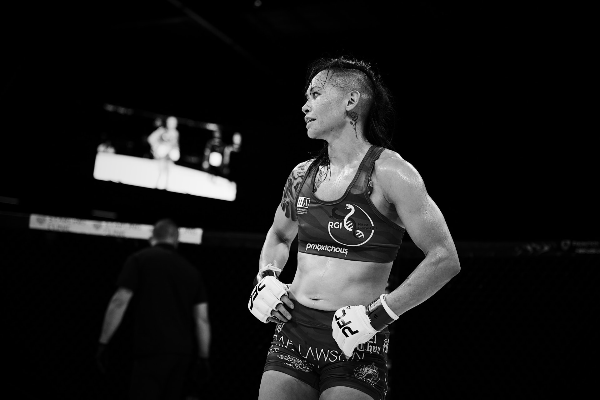 Katty Strite standing in the cage during a PFC fight, hands on hips, ready
