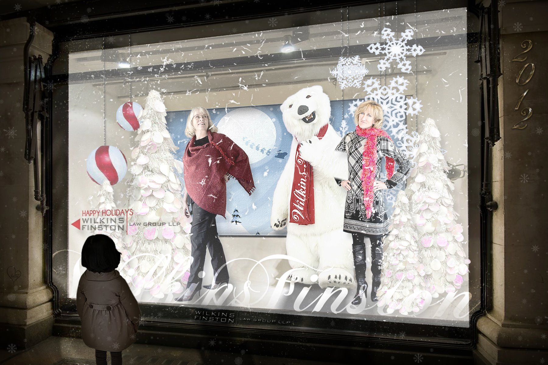 Wilkins Finston Friedman holiday window display with polar bear, snowflakes and brand lockup