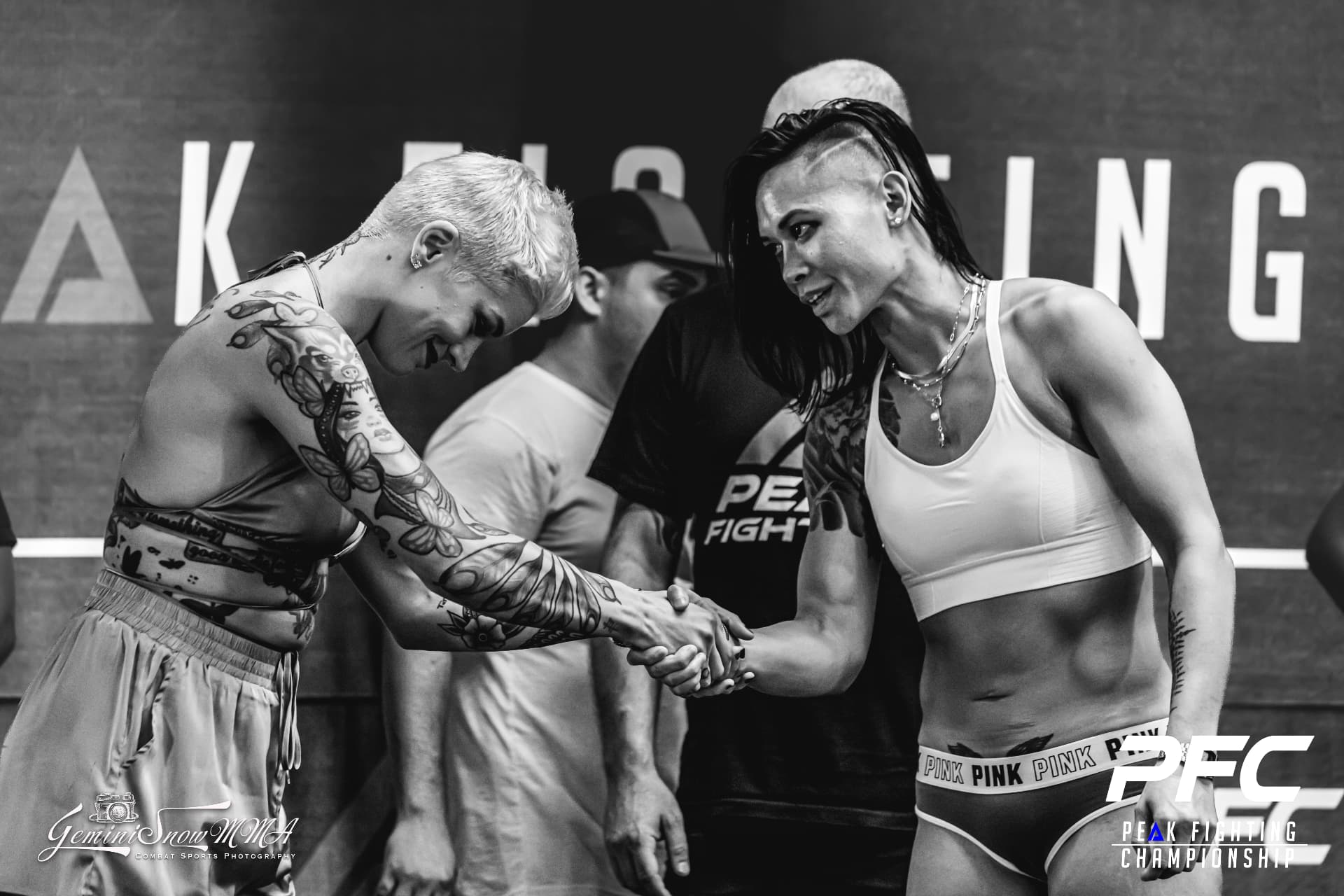 Katty Strite shaking hands with another fighter inside the Peak Fighting Championship ring